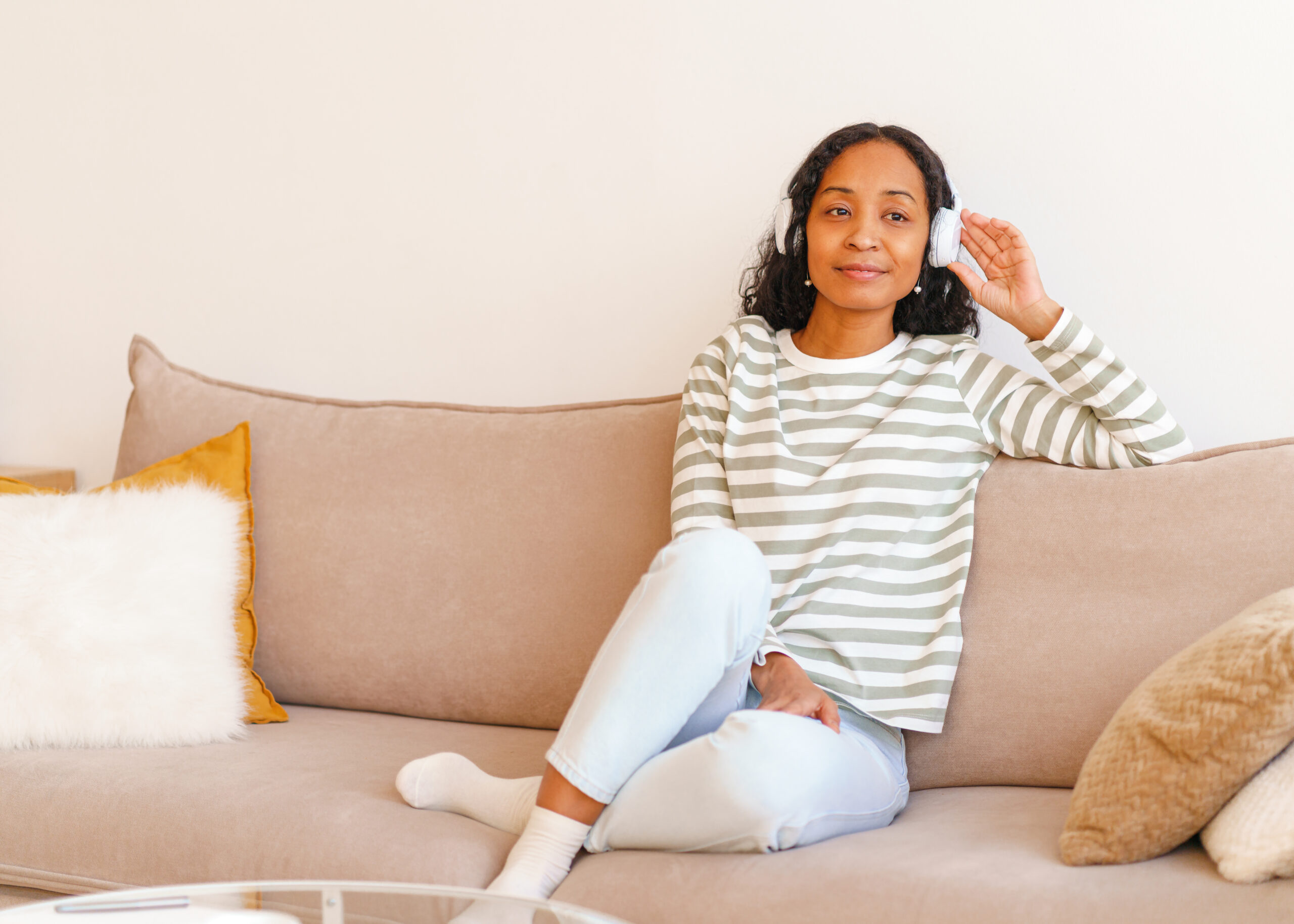 woman listening on couch