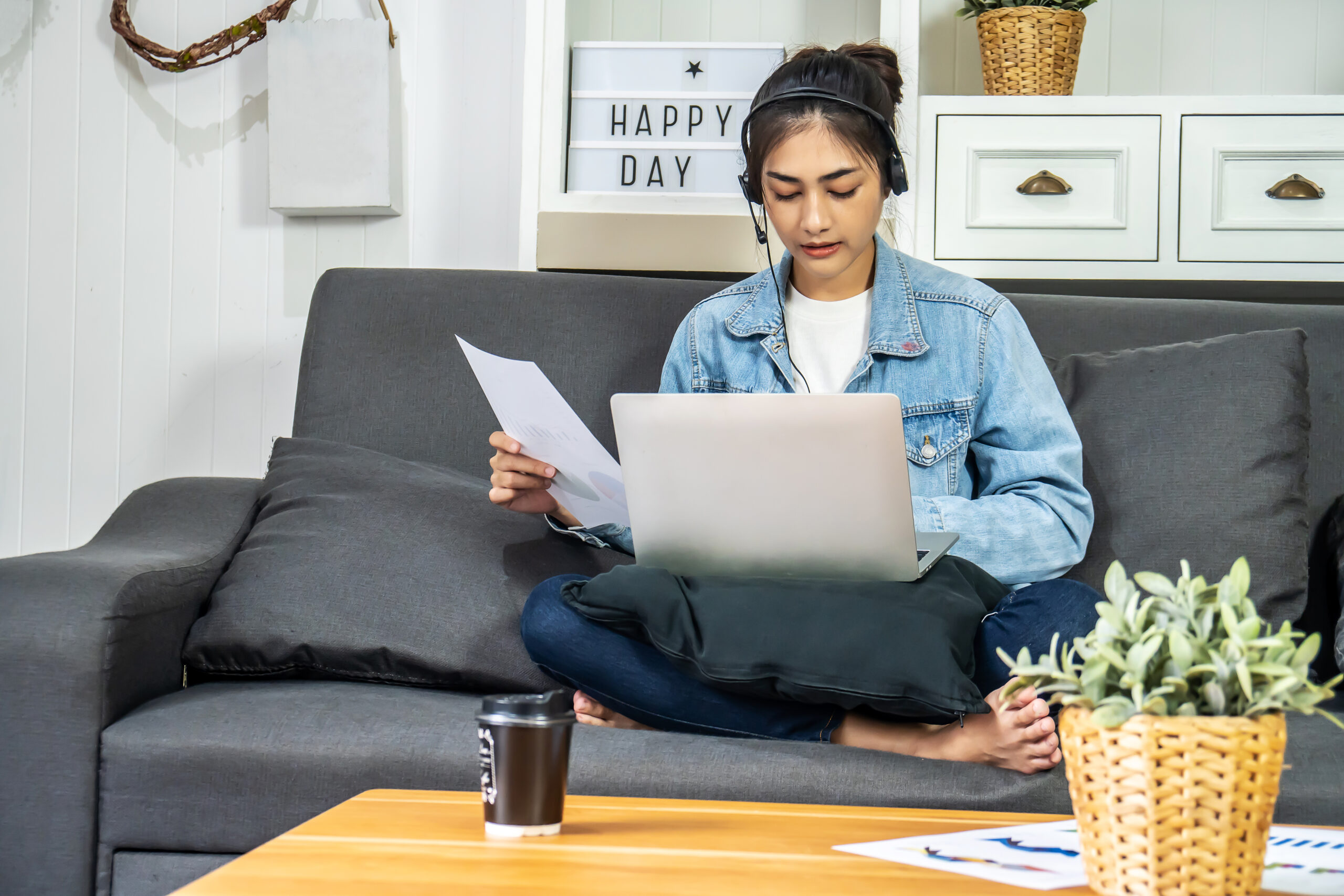 woman listening while working on couch